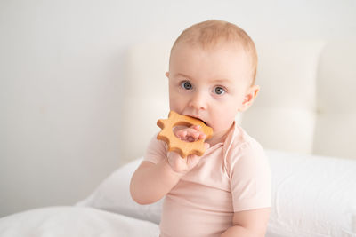 Portrait of cute baby girl holding teddy bear