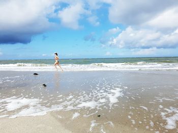 Full length of man on beach against sky