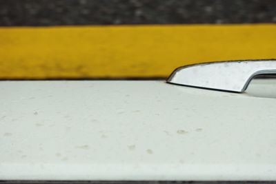 Close-up of wet yellow car