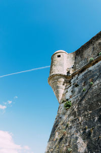 Low angle view of building against blue sky