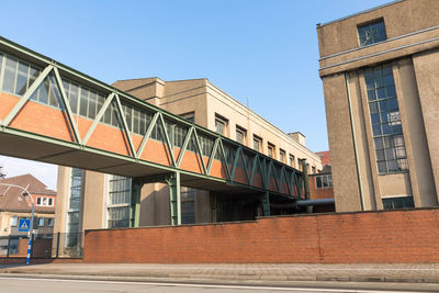 Low angle view of bridge against buildings in city