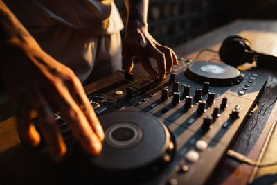 Midsection of man using sound mixer