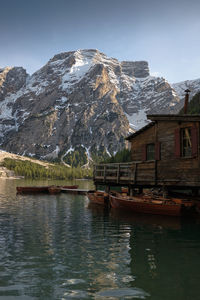 Scenic view of lake by snowcapped mountains against sky