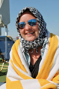 Portrait of smiling woman wearing sunglasses and headscarf