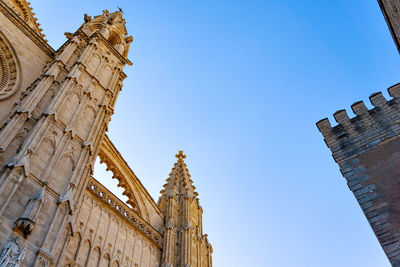 Low angle view of historical building against clear blue sky