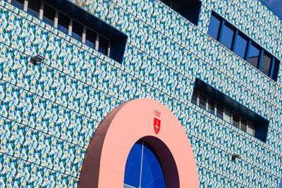 Low angle view of modern building against blue sky