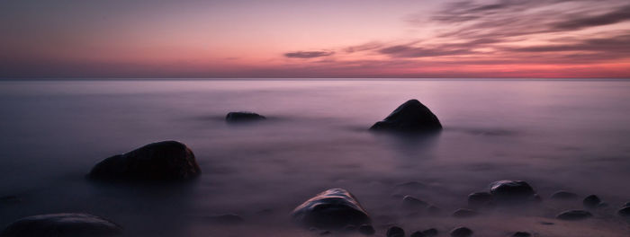 Scenic view of sea against sky at sunset