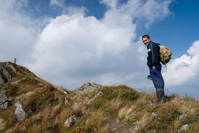 Full length of man standing on mountain against sky