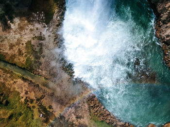 High angle view of water flowing through rocks