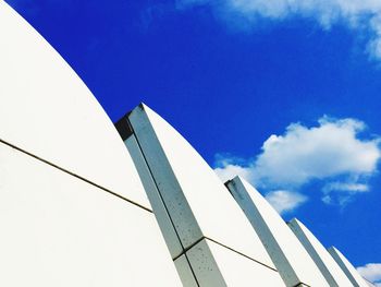 Low angle view of modern building against blue sky