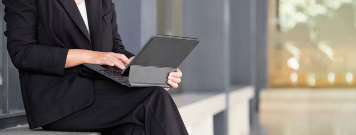 Low angle view of woman using mobile phone