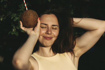 Close-up portrait of young woman with eyes closed