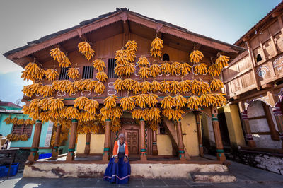 Woman outside temple against building