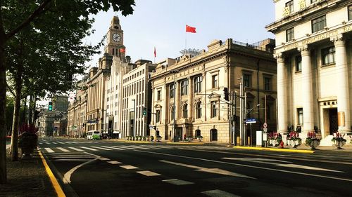 Cars on road by buildings in city