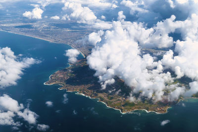 Aerial view of sea and mountains against sky