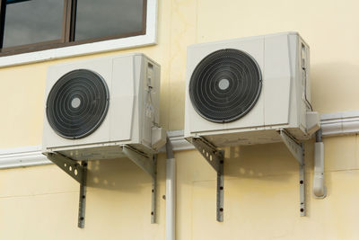 Close-up of electric fan on wall