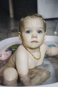 Portrait of cute baby in bathtub