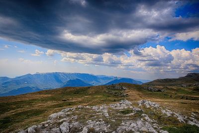 Scenic view of landscape against cloudy sky