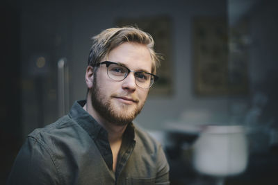 Portrait of confident male computer programmer in office