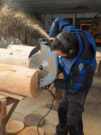 Man working on wood in workshop