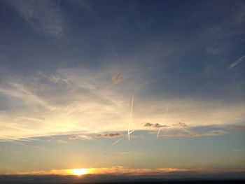 Vapor trail in sky during sunset