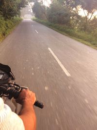 Low section of man on tire track on road