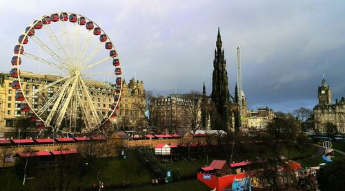 Ferris wheel in city against sky