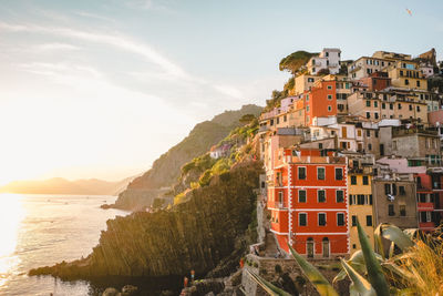 Scenic view of sea by buildings against sky