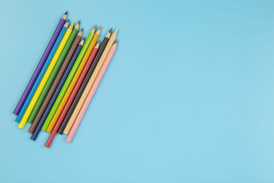 Close-up of colored pencils against blue background