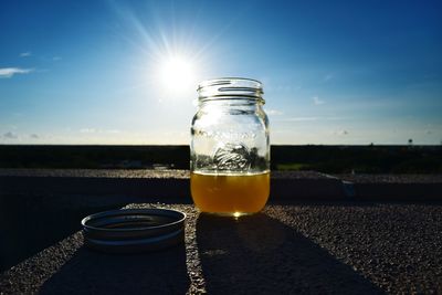 Close-up of drink on table against sky during sunset