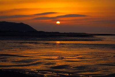 Scenic view of sea against romantic sky at sunset