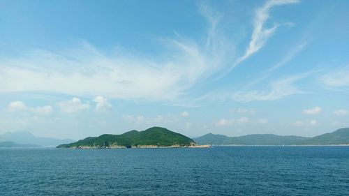 View of calm sea against mountain range