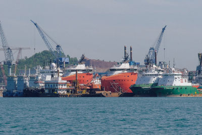 Commercial dock by sea against sky