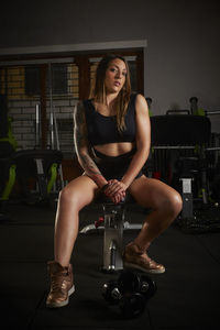 Portrait of woman sitting at gym