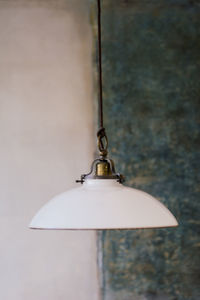 Close-up of lamp against wall