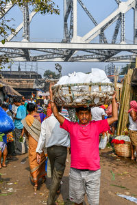 Group of people at market stall in city