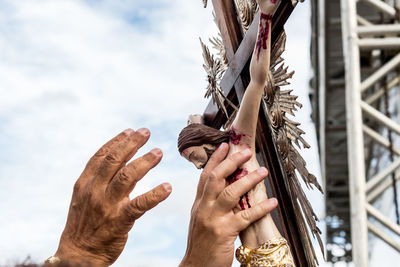 Catholics are seen touching the image of jesus christ during an open-air mass at the bonfim church 