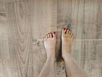 Low section of person wearing shoes on floor