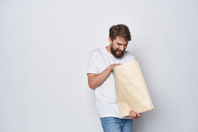 Young man standing against white background