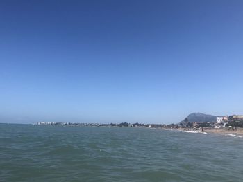 Scenic view of sea against clear blue sky