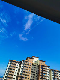 Low angle view of buildings against blue sky