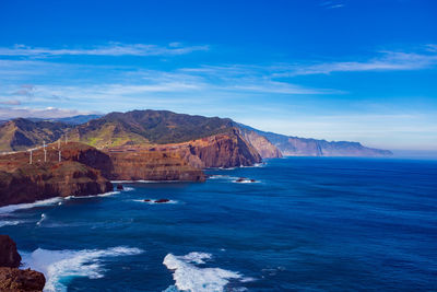 Scenic view of sea against blue sky