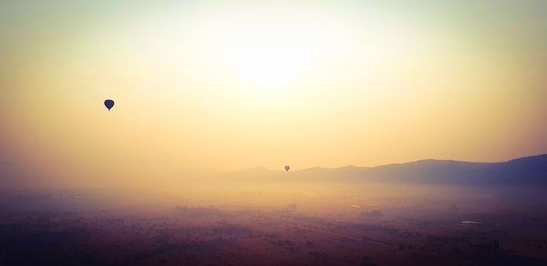 Silhouette of hot air balloon against sky during sunset