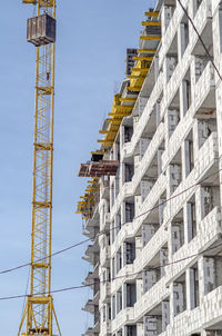 Construction of multi-storey building. yellow crane