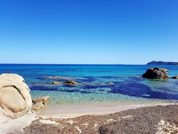 Scenic view of sea against clear blue sky