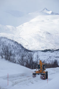 Scenic view of snow covered field against sky