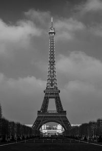 Eiffel tower against cloudy sky