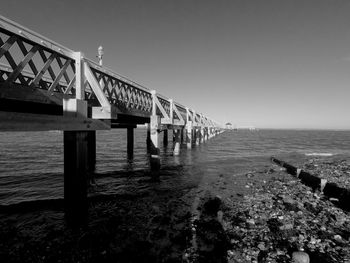 Pier over sea against clear sky