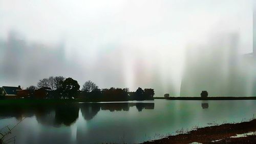 Scenic view of rainbow over trees against sky