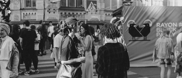 Group of people walking on street in city